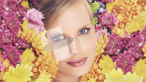 Image of Woman, portrait and flowers with makeup for beauty, creativity and wellness with spring aesthetic and floral art. Model, organic cosmetics and carnation plants for facial glow, smile and flowerbed