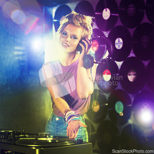 Image of Nightclub, DJ and portrait of woman playing music with headphones and vinyl record on table. Techno, rave and musician at concert, event mixing sound and audio for entertainment at party at night