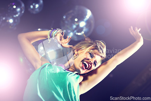 Image of Happy, woman and dance at club with disco, music and movement with energy at party. Girl, smile and enjoy rave culture at techno, nightclub and person moving to sound or audio at event from low angle