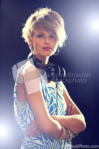 Image of Portrait, smile and headphones with woman, arms crossed and dj with mixes, online sound and audio track. Face, person or girl with headset or lights with hip hop and podcast on dark studio background