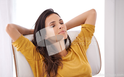 Image of Break, sleeping and woman in a chair in a home with tired, smile and calm in a lounge and living room. Happy, chill and female freelancer in the morning sitting with peace and nap with rest from work