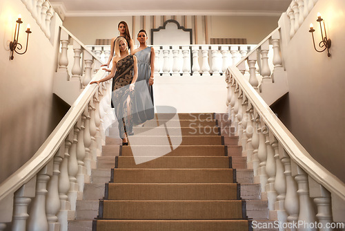 Image of Women, stairs and dress for gala, event and luxury party with confidence and fashion. Friends, classy and elegant group with expensive, fancy and designer clothes with glamour and gown at mansion