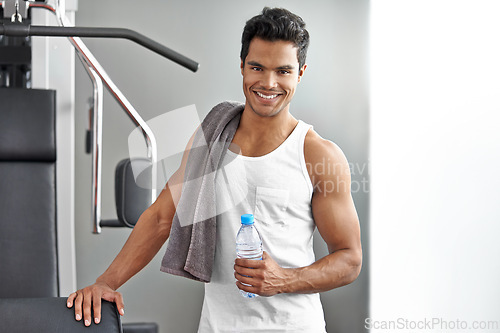 Image of Fitness, portrait and happy man with water at gym for weightlifting, training or wellness, exercise or cardio. Face, smile and male bodybuilder with sports drink for workout, recovery or hydration