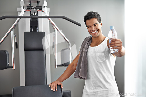 Image of Happy, portrait and man at gym with water bottle for recovery after exercise for body building. Healthy, fitness and person relax after workout with hydration for benefits to wellness in Mexico