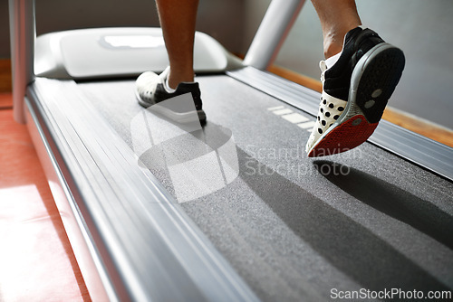 Image of Fitness, feet and person running on treadmill in gym for health, wellness and body training. Active, shoes and closeup of athlete with workout or exercise on cardio machine at sports center.