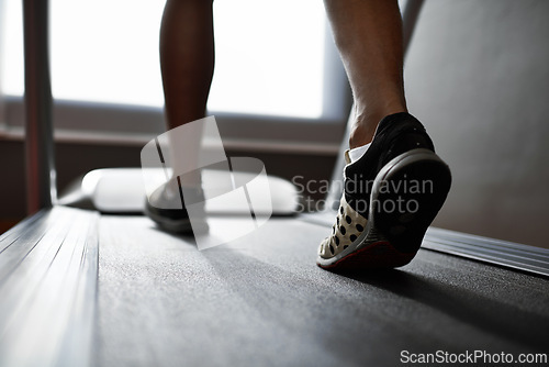 Image of Sports, feet and person running on treadmill in gym for health, wellness and body training. Active, shoes and closeup of athlete with workout or exercise on cardio machine at fitness center.