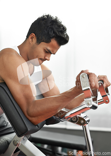 Image of Bench, weights and man with gym machine, exercise and challenge with endurance and progress. Bodybuilder, person and guy in a health center, strong and fitness with strength training and