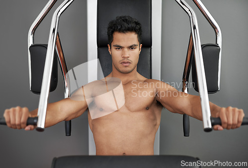 Image of Sports, resistance exercise and man in gym for arm muscle training for health, wellness and strength. Portrait, body and young male athlete on machine with weights for bodybuilding in fitness center.