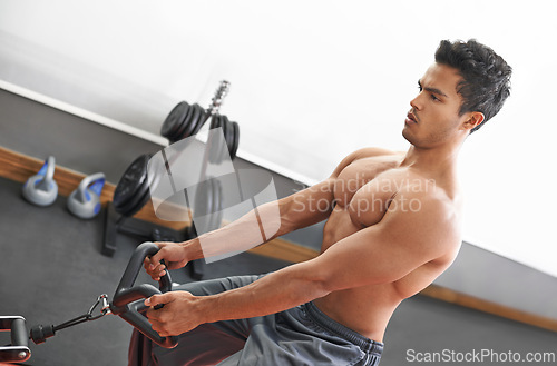 Image of Man, workout and cable exercise for arms in gym or muscle performance or bodybuilder training, fitness or strong. Male person, shirtless and equipment in Miami for chest routine, health or wellbeing