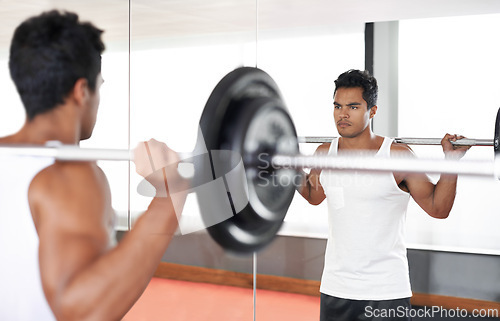 Image of Man, barbell and weightlifting at mirror for training exercise as bodybuilder for workout strength, wellness or routine. Male person, equipment and reflection in Miami for healthy, biceps or sport