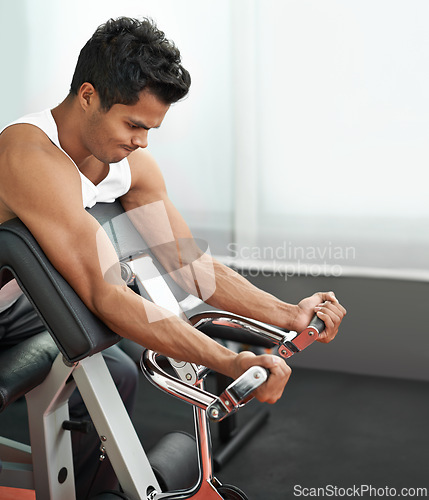 Image of Healthy, weights and man with gym machine, exercise and challenge with endurance and progress. Bodybuilder, person and guy in a wellness center, strong and fitness with strength training and power