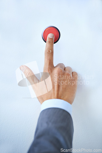 Image of Businessman, hands and red button for war, nuclear launch or initiation on a blue studio background. Closeup of man or president touching switch for nuke, control or emergency in safety or security