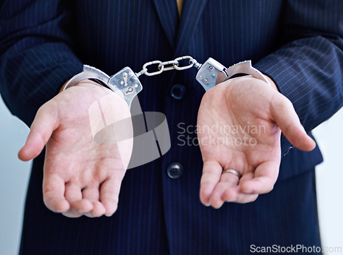 Image of Hands, person in business and handcuffs for fraud or bribery, suspicious professional deal with justice or jail. Crime, corruption or money laundry, shackles for prison with thief or criminal