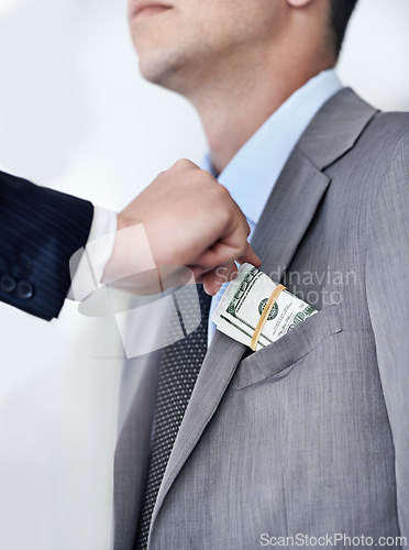 Image of Businessman, hands and bribe with money for fraud, payment or deal on a white studio background. Closeup of man or employee taking cash, dollar bill or paper in scam, secret or bribery from colleague