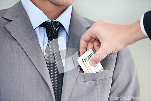 Image of Businessman, hands and bribe with cash for fraud, payment or deal on a white studio background. Closeup of man or employee taking money, dollar bill or paper in scam, secret or bribery from colleague