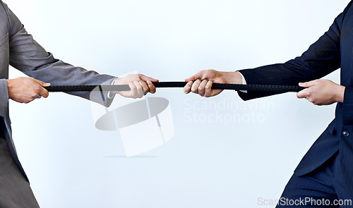 Image of Business people, rope and tug of war for challenge, mission or strength of rivals on a blue studio background. Closeup of employees or colleagues hands pulling strong cable for competition on mockup