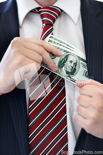 Image of Businessman, hands and money bribe in pocket for fraud, scam or secret on a white studio background. Closeup of employee with cash, dollar bills or finance in bribery, deal or financial exchange