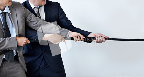 Image of Hands, partnership and tug of war with businessmen in studio for collaboration, competition or effort. Teamwork, rope and challenge with corporate people pulling together for strength or struggle