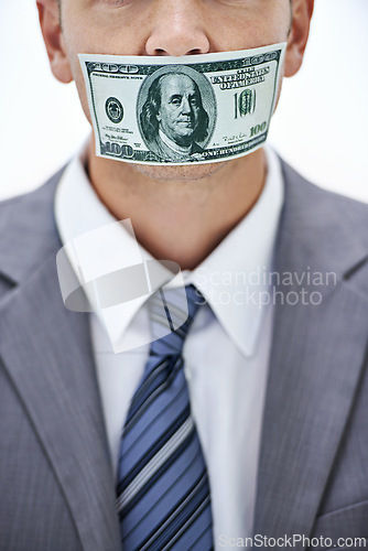 Image of Business man, cash and mouth for silence, bribe or corruption with suit in studio by white background. Person, money and quiet for corporate crime with fraud, finance or illegal payment at job in USA