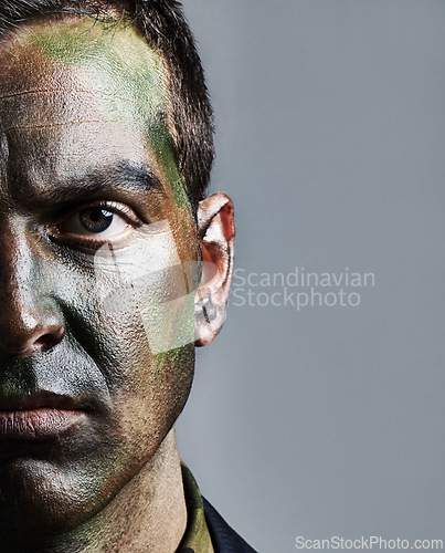 Image of Man, portrait and soldier with face paint for camouflage, military war or battle on a gray studio background. Closeup of male person, army or commander with color dye in undercover disguise on mockup