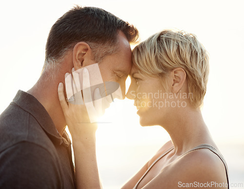 Image of Man, woman and love embrace at sunset for outdoor beach holiday or honeymoon connection, summer or vacation. Couple, happy and California together for sea relax or paradise, relationship or marriage