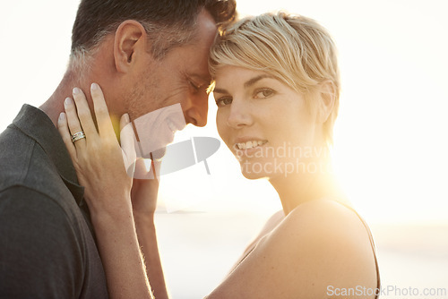 Image of Couple, beach and sunset embrace on holiday for marriage commitment for vacation, summer or travel. Man, woman and connection in evening at California paradise for relax date, happiness or outdoor