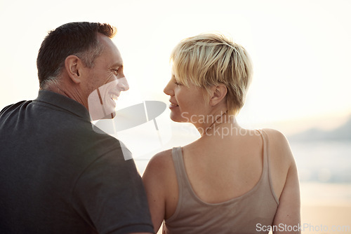 Image of Couple, smile and beach relax at sunset in summer on tropical island for paradise, marriage or stress relief. Man, woman and evening in California together for ocean view or travel, peace or date