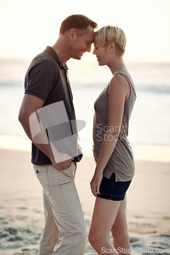 Image of Couple, love and smile on beach with bonding for honeymoon date and weekend holiday in Seychelles. Relax, man and woman with relationship, happy and care on sea sand for vacation, travel or adventure