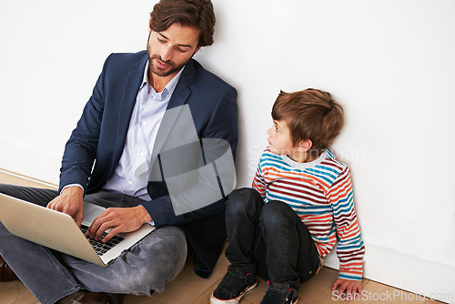 Image of Father, son and relax on floor with laptop for remote work with video streaming, online games and movies in home. Family, parent and child with technology on ground for bonding, communication and fun