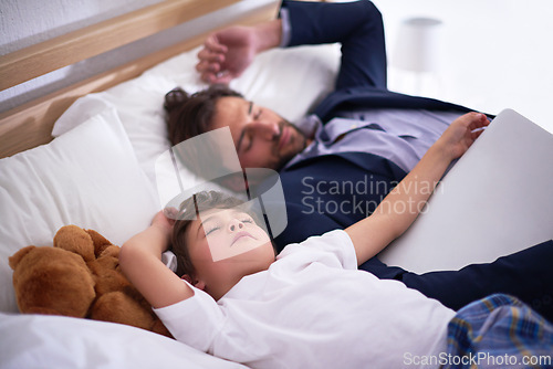 Image of Businessman, sleeping and together with child in house for comfort, relax and pyjamas to dream in bedroom. Tired, peace and dad with son on bed, cute and sweet moment for parent after work in home