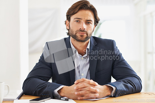 Image of Desk, confidence and portrait of serious businessman with pride, paperwork and serious financial analyst in office. Consultant, business advisor or man with pride, documents and notes at startup.