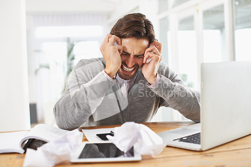 Image of Man, laptop and frustrated at home office with paper on desk, overtime and stress to meet deadline. Startup, home, and headache with research on information for growth with tablet and business notes