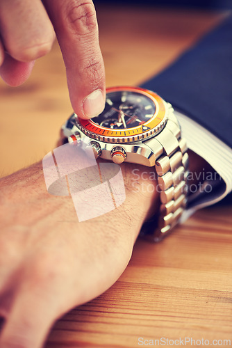 Image of Hands, table and wristwatch with pointing time for deadline at office, table and schedule for business. Closeup, check and appointment for work with commitment, punctual and plan for meeting