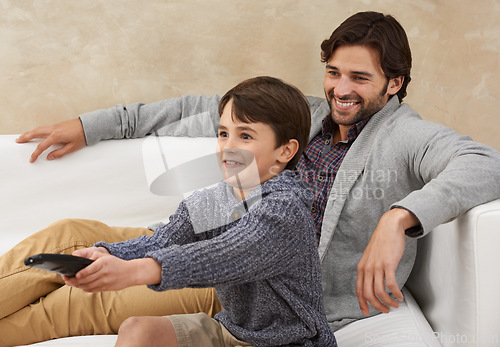 Image of Relax, TV and father and child on sofa with remote for bonding, smile and fun in living room. Family, parents and dad with young son for cartoon, watching movies and entertainment in home