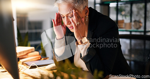 Image of CEO, stress and headache by computer in office with tension for burnout, frustrated and overworked at night. Woman, boss and anxiety with hand on temples for pressure, migraine and pain at workplace