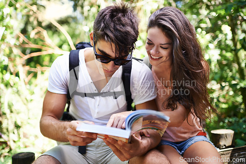Image of Couple, map and backpack for hiking in jungle with reading for thinking, holiday or search by trees. Man, woman and bag for trekking, direction or journey in forest with book for location in Colombia