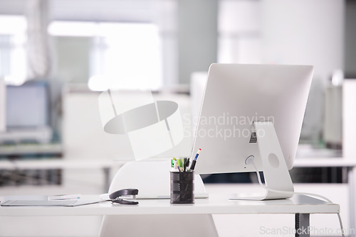 Image of Empty office, computer and business interior on desk, company furniture and workspace. Vacant workplace, corporate setup and technology on table, professional design and detail at modern agency