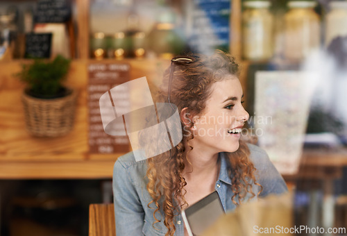 Image of Coffee shop, relax and woman in window with laptop for internet, social networking and website. Happy, smile and person on computer in restaurant, cafe and diner for caffeine, beverage and cappuccino