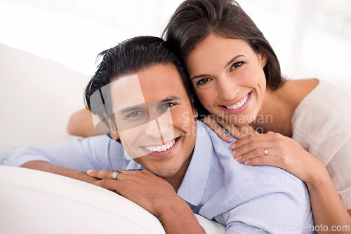 Image of Relax, embrace and portrait of happy couple on sofa for weekend bonding, romance and connection in home. Love, support and trust in marriage, man and woman on couch with hug, wellness and smile.