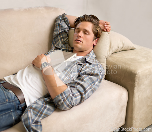 Image of Home, man and sleep on couch with book to read, break and tired in living room with fatigue. House, nap and exhausted on sofa to rest with dreams for wellness, stress relief, self care and relax.