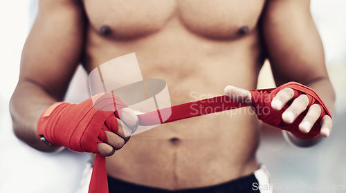 Image of Closeup, man and wrap of hand for fight, martial arts and boxing at fitness and workout studio. Strap, boxer and gym to exercise, practice and training for health, energy and strength for protection