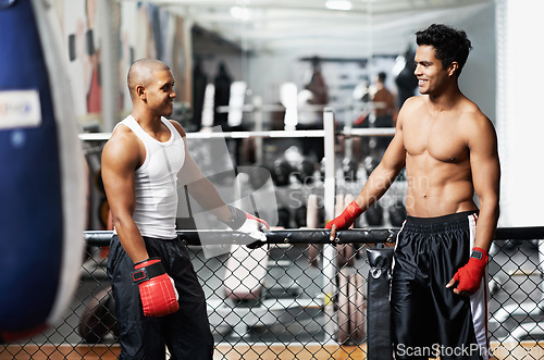 Image of Fitness, conversation and fighter in gym with coach for training, self defense or combat training. Exercise, sports or talking with muscular man and personal trainer in preparation for boxing