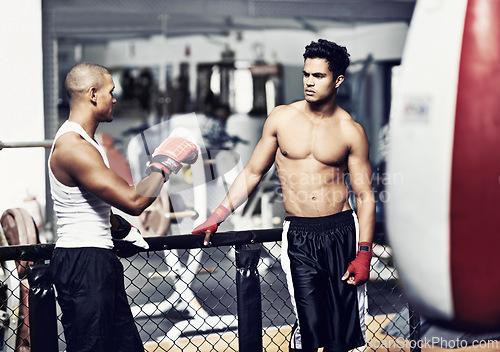 Image of Exercise, talking and fighter in gym with coach for training, self defense or combat training. Fitness, sports or boxing with shirtless man and personal trainer in preparation for competition