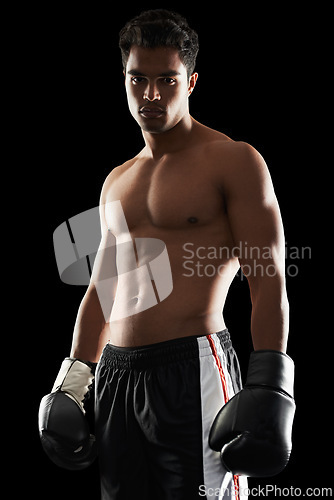 Image of Portrait, man and boxer in studio for sports, training and workout for healthy body isolated on a black background. Fighter, serious athlete and person with gloves for fitness or exercise in Brazil