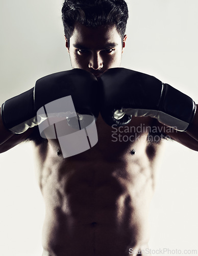 Image of Portrait, man and boxer in stance for sports, training and workout for body health isolated on white studio background. Fighter, serious face and athlete in gloves for fitness or exercise in Brazil