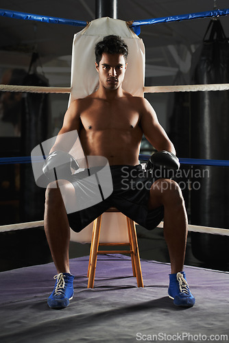 Image of Portrait, man and boxing ring for sports, corner or training for competition in gym for body health. Fighter, athlete and serious person with gloves for fitness, exercise or workout at club in Brazil