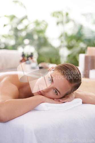 Image of Female person, spa and portrait for wellness, health and self care for relaxation and portrait and therapy. Woman, luxury resort and body treatment for beauty, skincare and detox on massage table