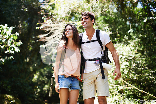 Image of Hiking, happy and couple in nature walking for adventure, freedom and explore together outdoors. Dating, travel and man and woman on mountain for holiday, vacation and trekking for wellness in forest