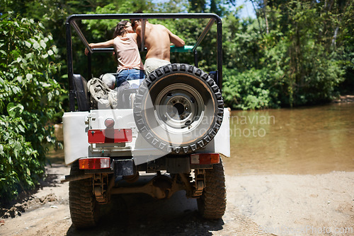 Image of Couple, forest and adventure with 4x4, drive and outdoor with love, care or nature with river in summer. People, man and woman with back in vehicle, car or journey on road trip in jungle in Colombia