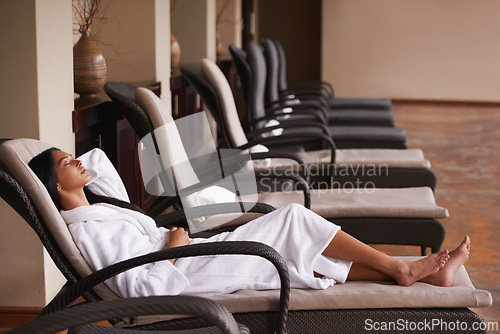 Image of Spa, relax and woman in chair for beauty, skincare and wellness treatment in luxury hotel. Resort, hospitality and person lying in salon for therapy, massage and cosmetics for calm, pamper and rest